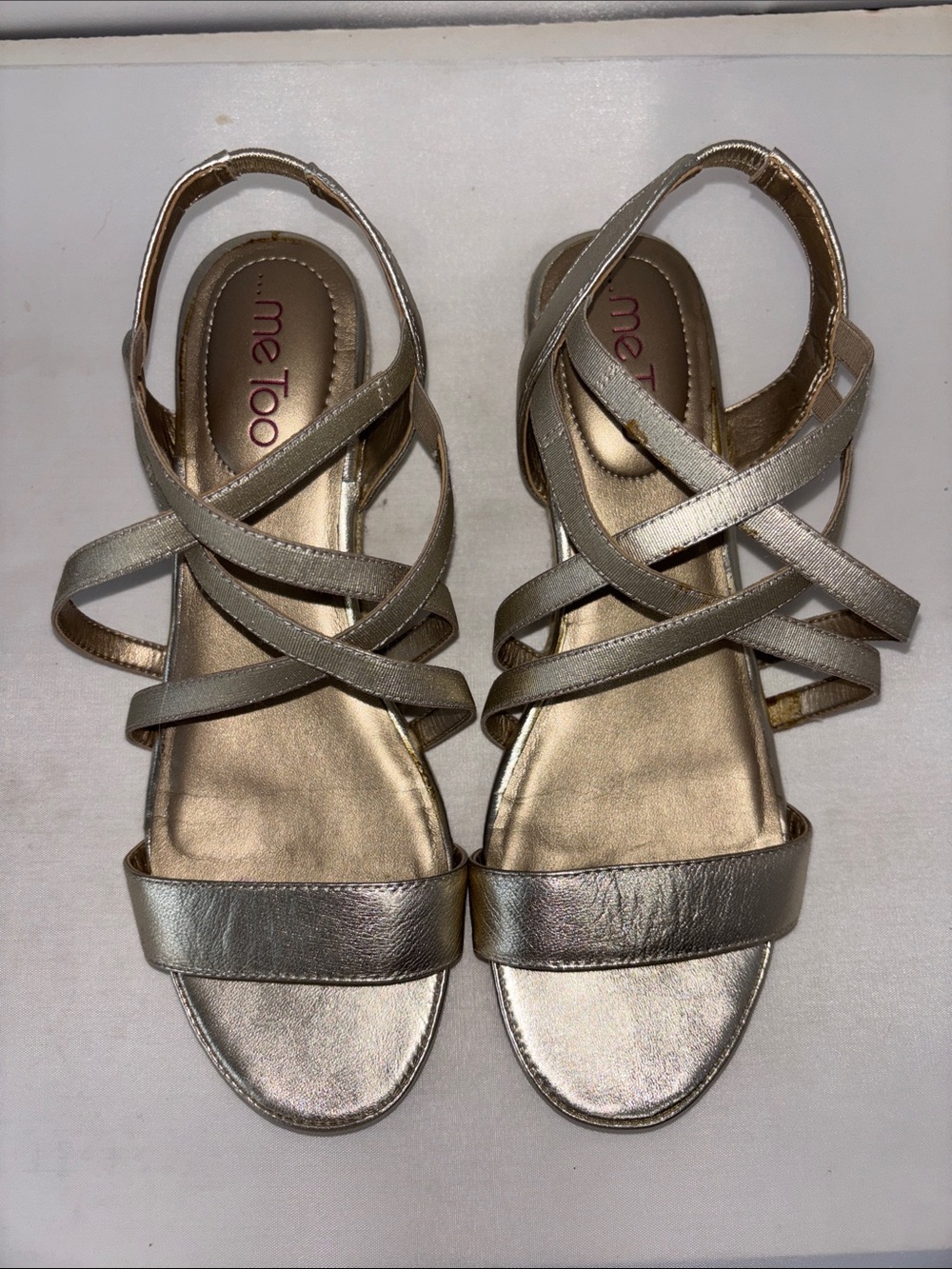 Me Too metallic gold strappy low wedge sandals.